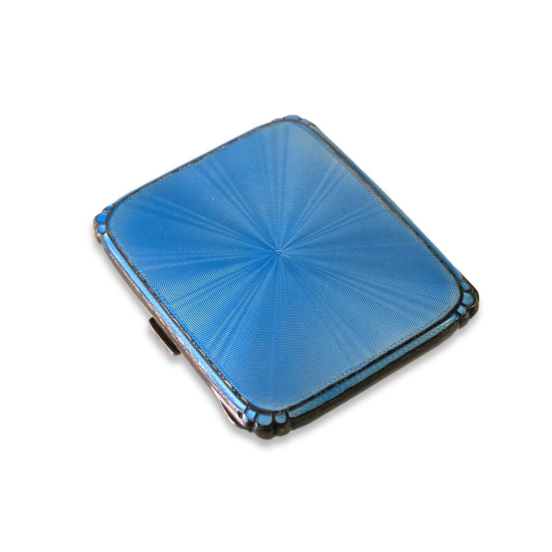 AN ART DECO SILVER AND ENAMEL CIGARETTE CASE: AN ART DECO SILVER AND ENAMEL CIGARETTE CASE by Mappin & Webb, Birmingham, 1937, of shaped rectangular form with pale blue enamel and engine-turned decoration, the interior gilded. 8.2cm by 6.5cm 
