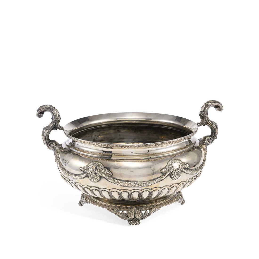 A LATE VICTORIAN SILVER TWO-HANDLED CENTERPIECE BOWL: A LATE VICTORIAN SILVER TWO-HANDLED CENTERPIECE BOWL by Mappin & Webb, London 1899, Regd No. 342140, of compressed circular form, with scroll form acanthus leaf handles, embossed decorative mask a