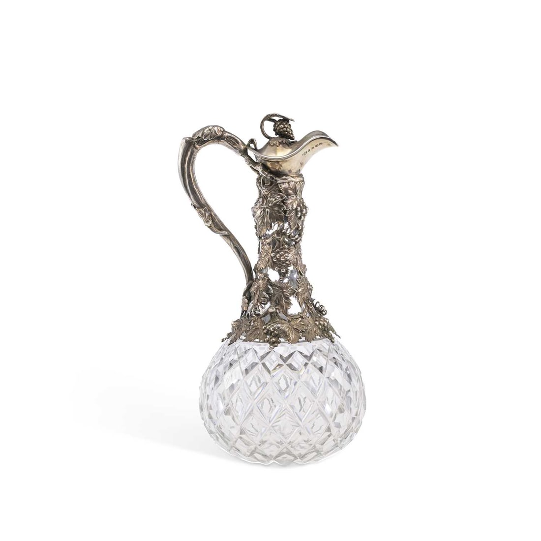 A VICTORIAN SILVER MOUNTED CUT-GLASS CLARET JUG: A VICTORIAN SILVER MOUNTED CUT-GLASS CLARET JUG by Cartwright, Hirons & Woodward (George Cartright, Joseph Hirons & Horace Woodward), Birmingham 1856, chased with grapes and vines, the finial 