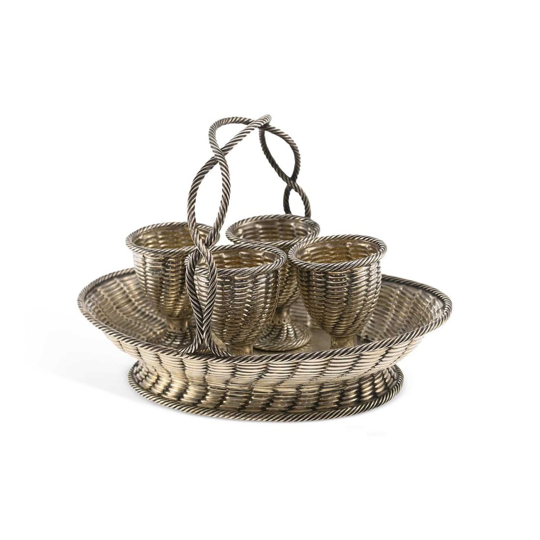 A VICTORIAN NOVELTY SILVER EGG CRUET: A VICTORIAN NOVELTY SILVER EGG CRUET by Robert Henel III, London 1860, in the form of a woven basket with four fitted egg cups and a twist handle. 20cm wide, 20.3 troy ounces