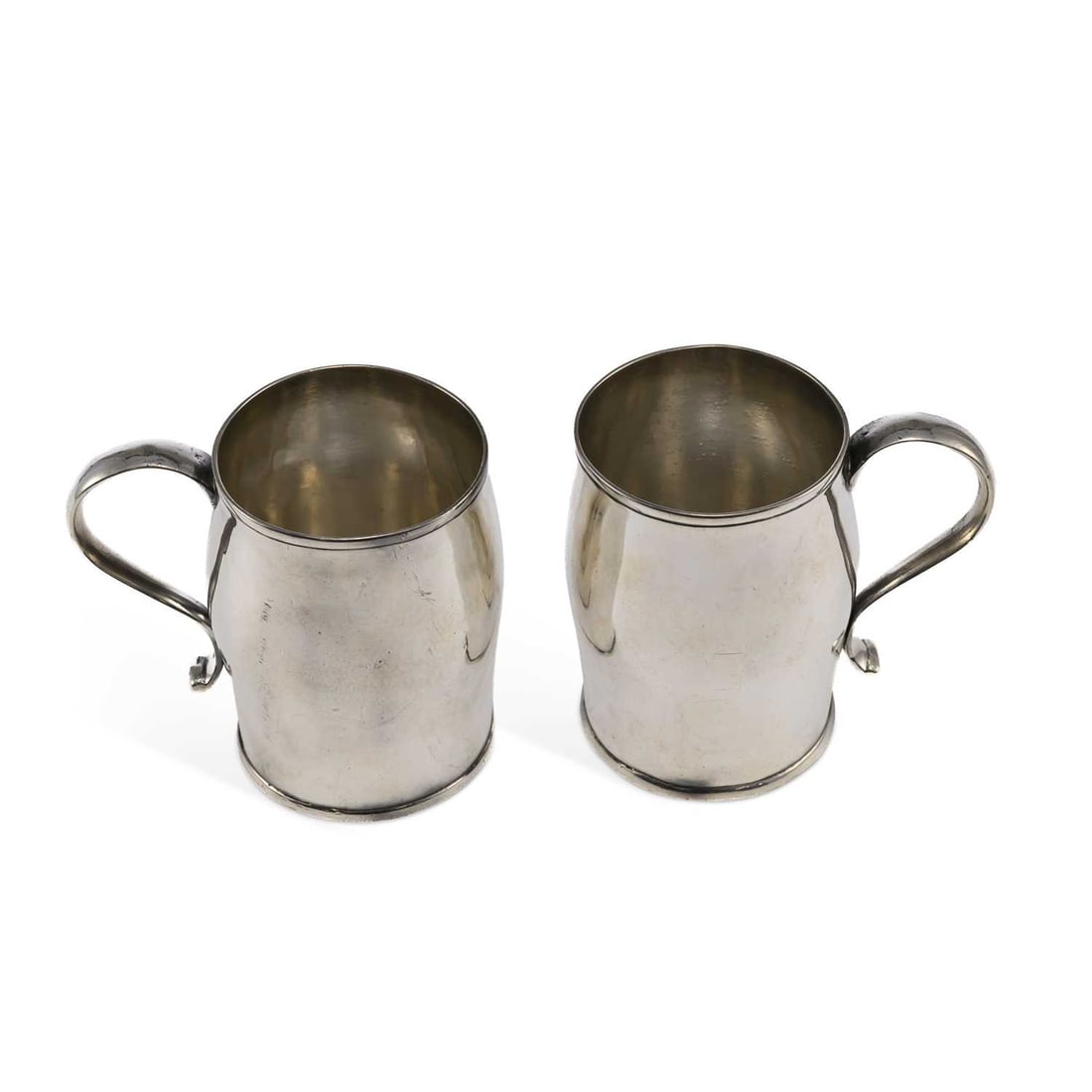 A PAIR OF GEORGE III PROVINCIAL SILVER MUGS: A PAIR OF GEORGE III PROVINCIAL SILVER MUGS by Richard Richardson II, Chester 1775, of plain baluster form with scroll handles on short circular foot. (2) 7.7cm high, 8.3 troy ounces gross