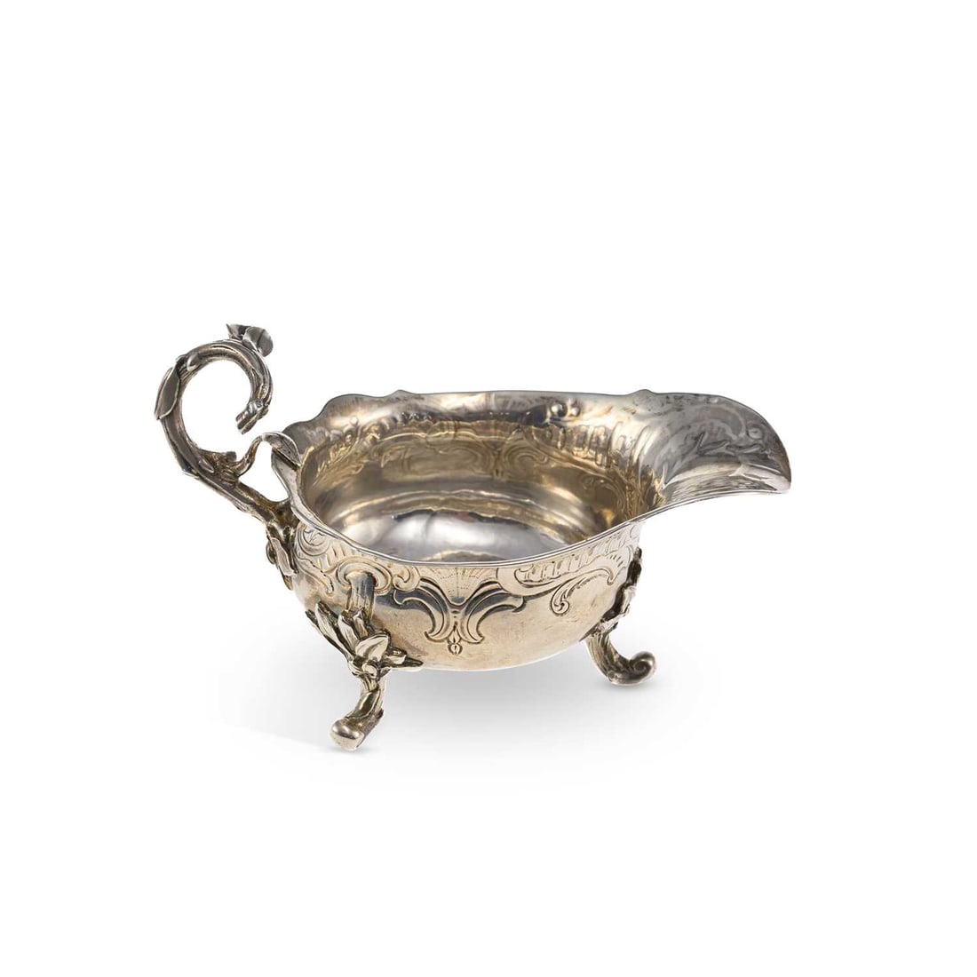 A GEORGE II SILVER CREAM BOAT: A GEORGE II SILVER CREAM BOAT by Paul Crespin, London, date letter rubbed, of squat oval form, the decorative handle in the form of a tree branch, chased decorated with leaf and scroll pattern, stags 