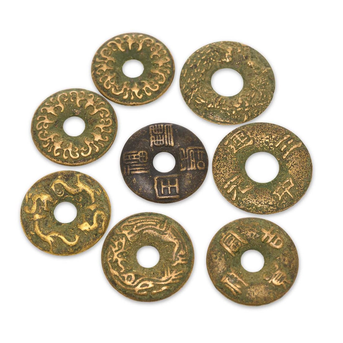 A COLLECTION OF EIGHT CHINESE BRONZE CASH-TYPE CHARMS: A COLLECTION OF EIGHT CHINESE BRONZE CASH-TYPE CHARMS