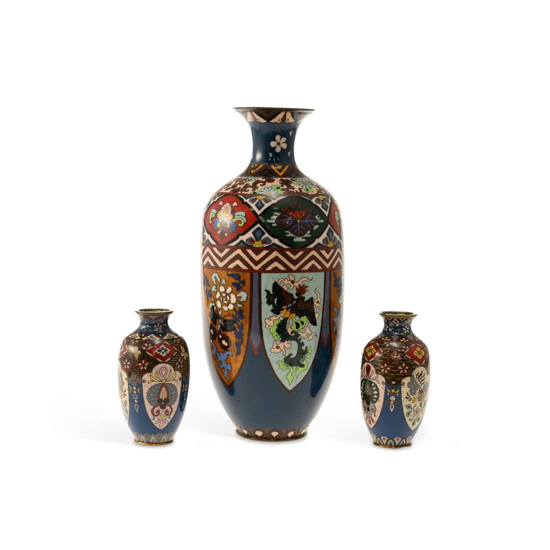 THREE JAPANESE CLOISONNÉ ENAMEL VASES MEIJI PERIOD: THREE JAPANESE CLOISONNÉ ENAMEL VASES MEIJI PERIOD comprising a large baluster vase and a smaller pair, each decorated with shaped panels of mythical birds, butterflies and flowers against dark blue 