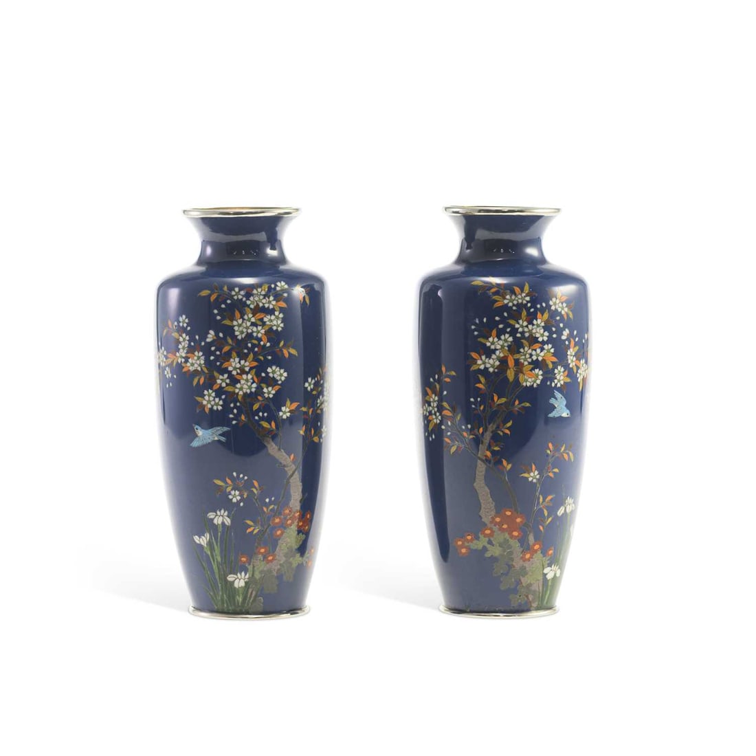 A PAIR OF JAPANESE BLUE GROUND CLOISONNÉ VASES MEIJI PERIOD: A PAIR OF JAPANESE BLUE GROUND CLOISONNÉ VASES MEIJI PERIOD decorated in silver wire with birds amongst flowering plants, on a blue ground. 18.5cm high