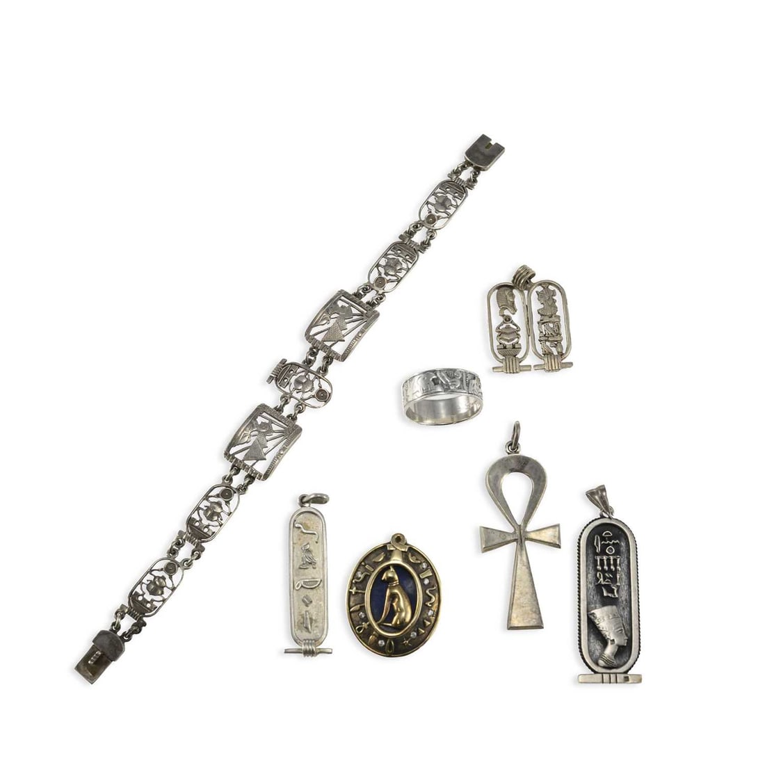 A GROUP OF SILVER JEWELLERY: A GROUP OF SILVER JEWELLERY including an Egyptian panel bracelet, the panels pierced with scarabs, sphinx and pyramids, hallmarked; an Egyptian ankh pendant, hallmarked; a silver-gilt and enamel