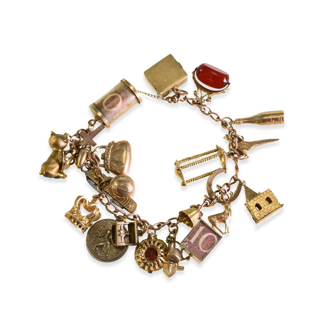 A 9 CARAT GOLD CHARM BRACELET: A 9 CARAT GOLD CHARM BRACELET the curb-link bracelet suspending an assortment of novelty charms, including a cat, horseshoe, crown, bottle, and fob. 18cm long (approx.), 52 grams gross Many charms are