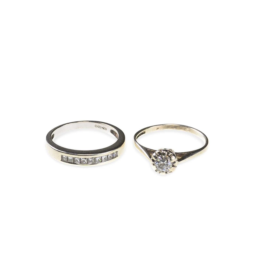 TWO 9 CARAT WHITE GOLD DIAMOND RINGS: TWO 9 CARAT WHITE GOLD DIAMOND RINGS comprising a solitaire diamond ring, hallmarked; and a princess-cut diamond half hoop ring, stamped '375'. (2) First stated diamond weight 0.33 carat, ring sizes L
