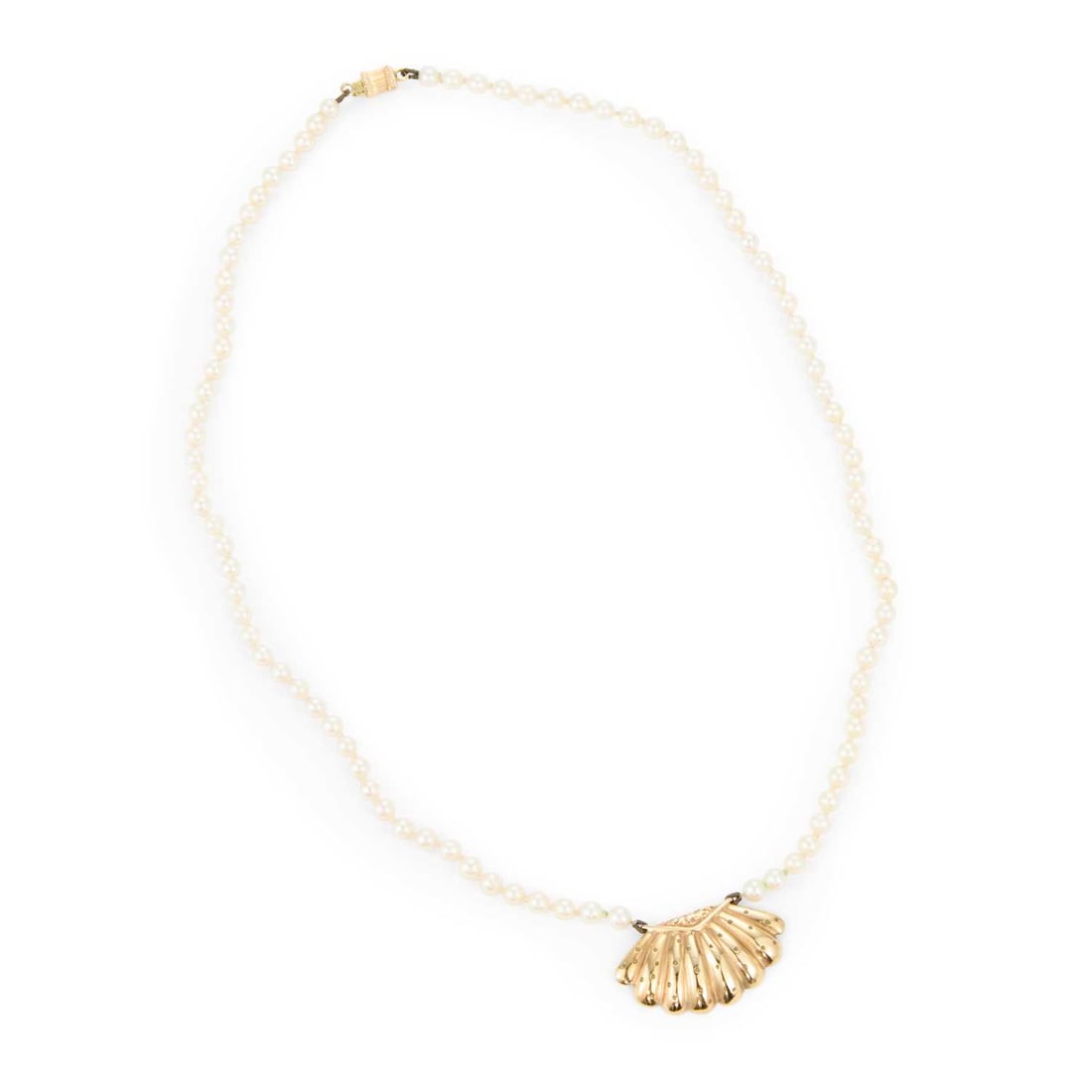 A CULTURED PEARL PENDANT NECKLACE: A CULTURED PEARL PENDANT NECKLACE a shell pendant to a strand of uniform cultured pearls, stamped '375'. Pendant 1.7cm by 2.7cm, 43cm long, 10 grams Good condition
