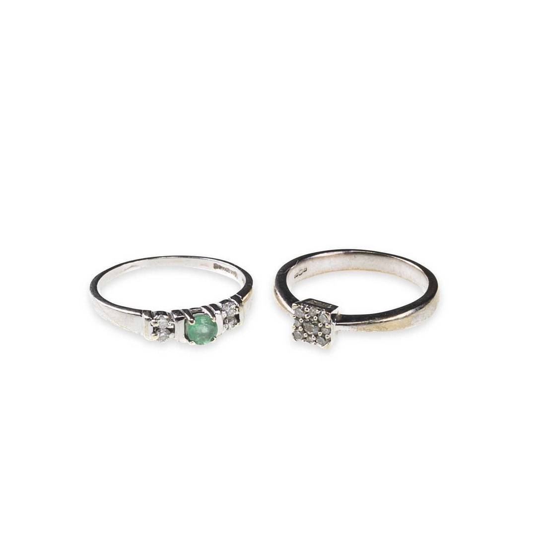 TWO 9 CARAT WHITE GOLD GEM-SET RINGS: TWO 9 CARAT WHITE GOLD GEM-SET RINGS comprising a diamond cluster ring, hallmarked; and an emerald and diamond ring, hallmarked. (2) Ring sizes M and N1/2, 4.5 grams gross Good condition