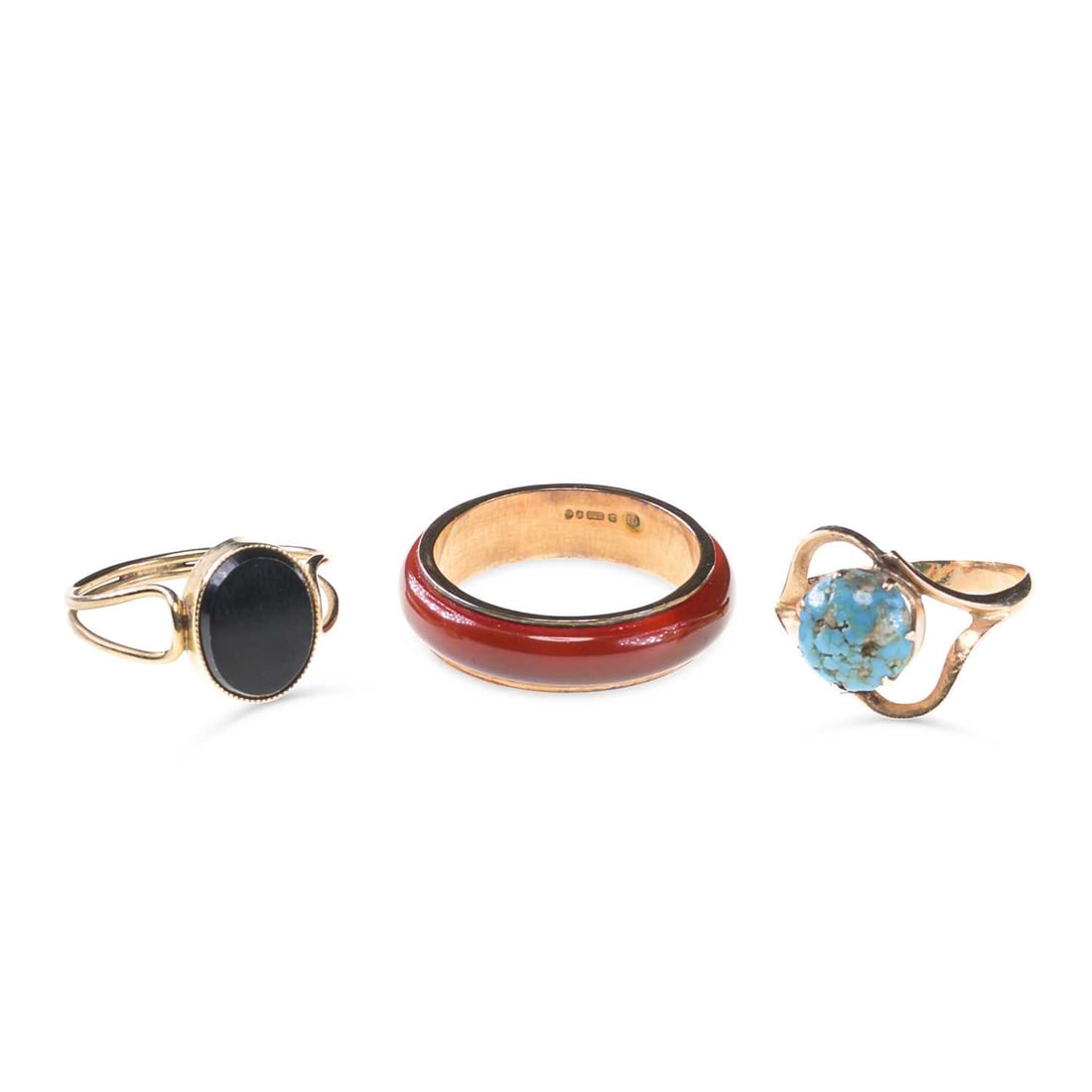 THREE 9 CARAT GOLD GEM-SET RINGS: THREE 9 CARAT GOLD GEM-SET RINGS comprising a carnelian band ring, hallmarked; a turquoise ring, unmarked; and an onyx ring, hallmarked (3). Ring sizes N and J and J1/2, 6 grams gross Good condition