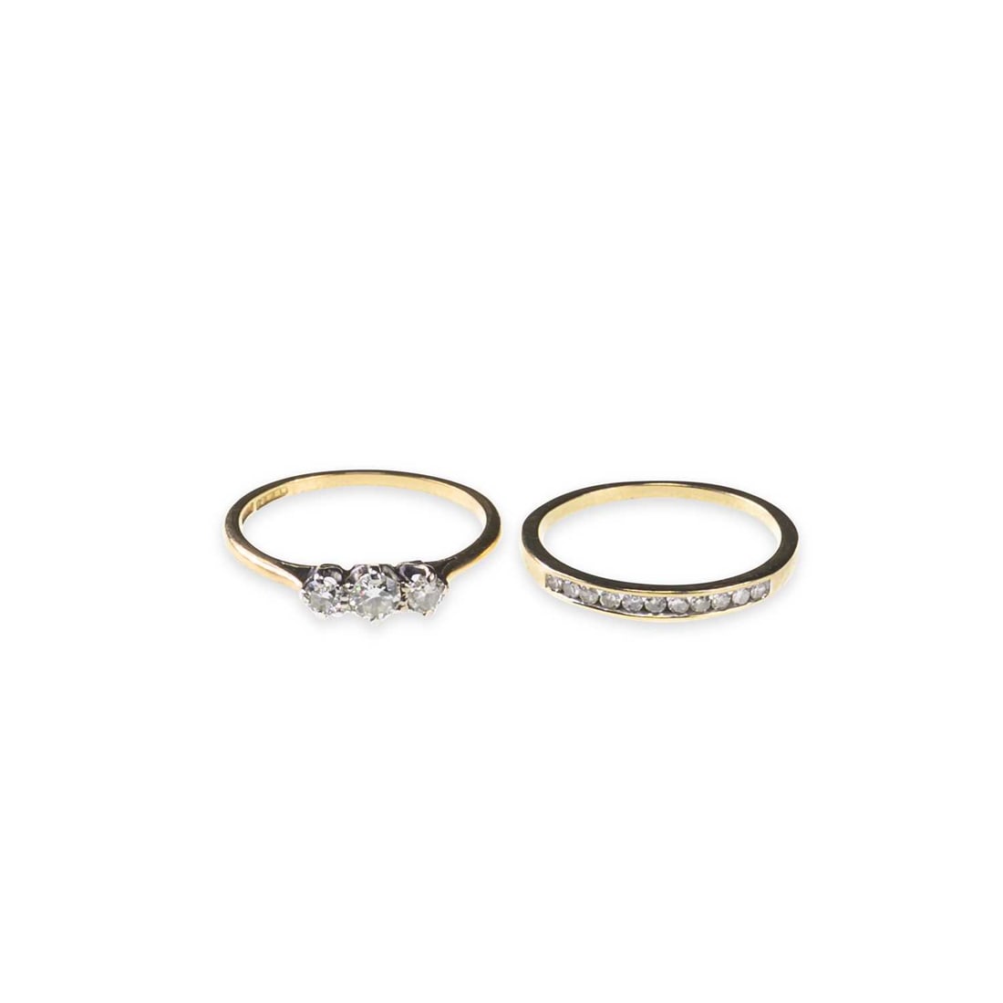 TWO 9 CARAT GOLD DIAMOND RINGS: TWO 9 CARAT GOLD DIAMOND RINGS comprising a diamond half hoop ring, stamped '375'; and a diamond three stone ring, hallmarked. (2) Second estimated total diamond weight 0.25 carat, ring sizes J1/2 and