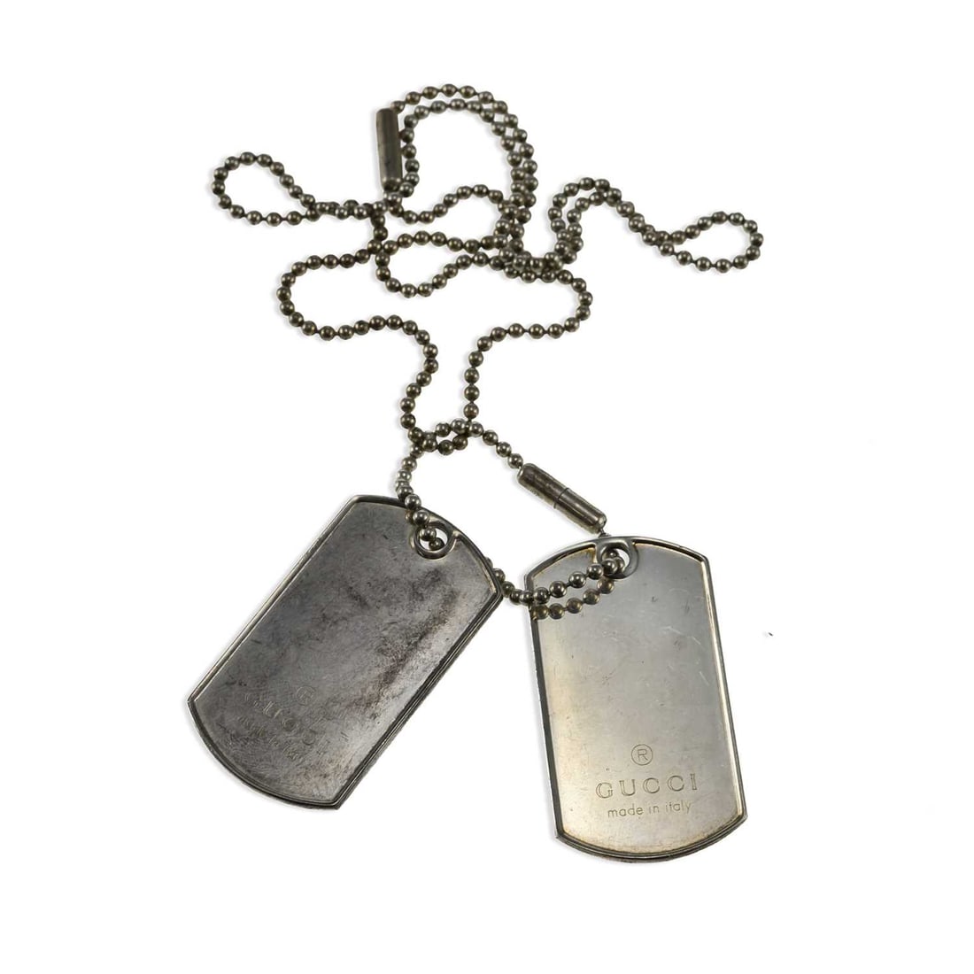 A GUCCI SILVER DOG TAG PENDANT NECKLACE: A GUCCI SILVER DOG TAG PENDANT NECKLACE the ball link chain suspended two rounded rectangular dog tags, each engraved GUCCI, with Italian hallmarks. Tags 5cm long, 54.4 grams