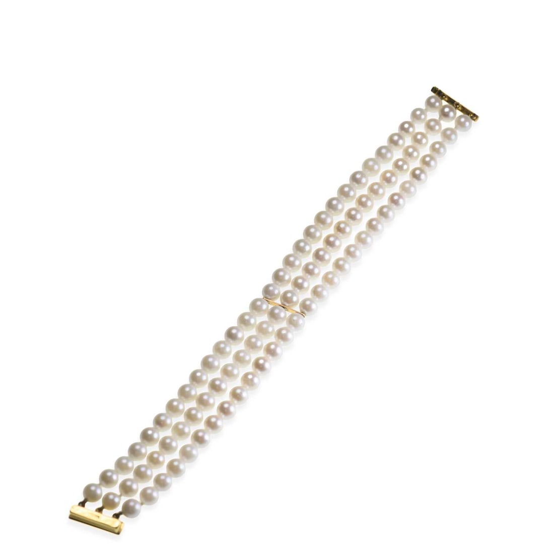 A CULTURED PEARL BRACELET: A CULTURED PEARL BRACELET three rows of uniform cultured pearls tied by bar links, with a bar clasp, stamped '375'. 19cm long, 2cm wide, 36 grams Good condition