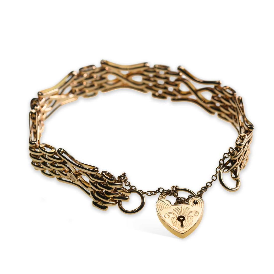 A 9 CARAT GOLD GATE LINK BRACELET WITH HEART PADLOCK CLASP: A 9 CARAT GOLD GATE LINK BRACELET WITH HEART PADLOCK CLASP of fancy infinity link design, with a foliate engraved padlock clasp, hallmarked London 1993. 19cm long, 21 grams Good condition