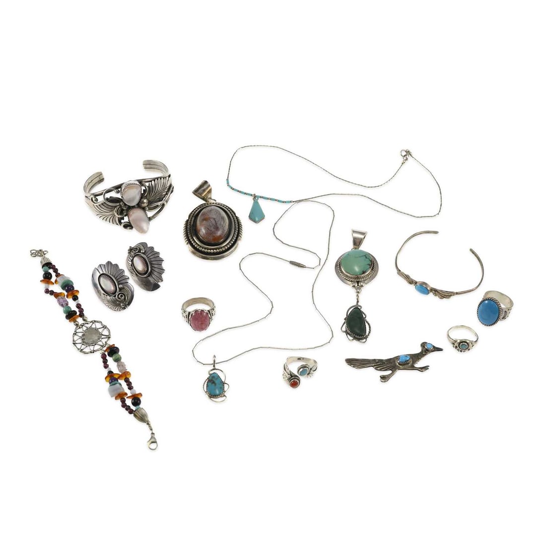 A GROUP OF NATIVE AMERICAN SILVER JEWELLERY: A GROUP OF NATIVE AMERICAN SILVER JEWELLERY including a pair of Phil Chapo stud earrings; a Ree Montoya foliate cuff bangle; a Ray Bennett pendant; etc. (14) First 3.7cm long, 175.3 grams gross