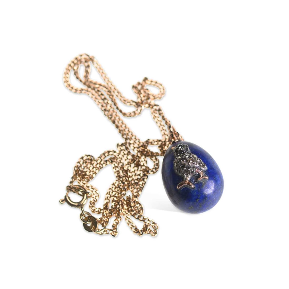 A RUSSIAN LAPIS LAZULI AND DIAMOND EGG PENDANT ON CHAIN: A RUSSIAN LAPIS LAZULI AND DIAMOND EGG PENDANT ON CHAIN the lapis lazuli egg applied with a rose-cut diamond set chick, to a gold bail, Russian marks, to a later 9 carat gold curb link chain. Pendant