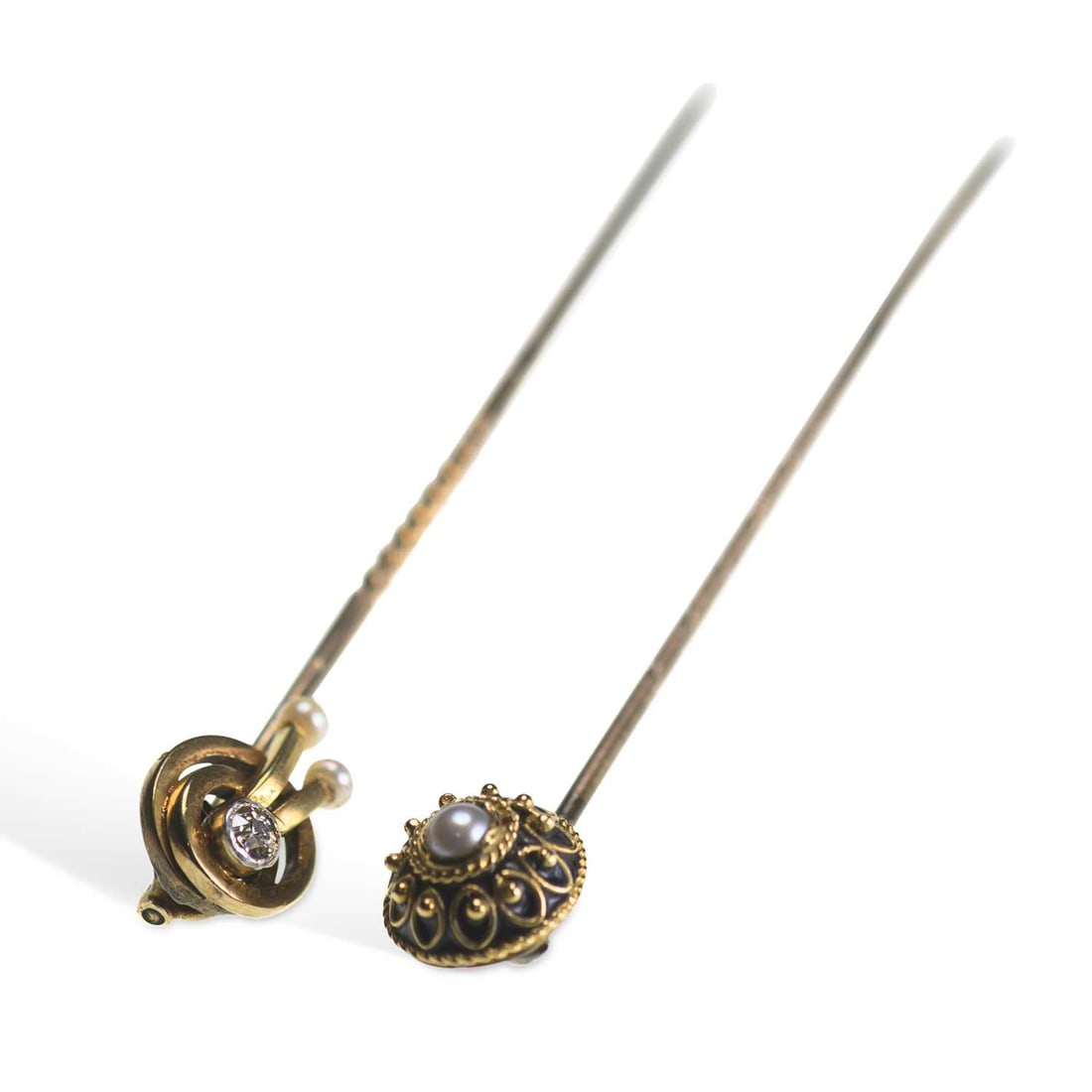 TWO GEM-SET STICKPINS: TWO GEM-SET STICKPINS comprising a diamond and seed pearl knot example, stamped '15CT'; and a seed pearl set cannatille example. (2) Heads 0.7cm diameter, 2.5 grams gross