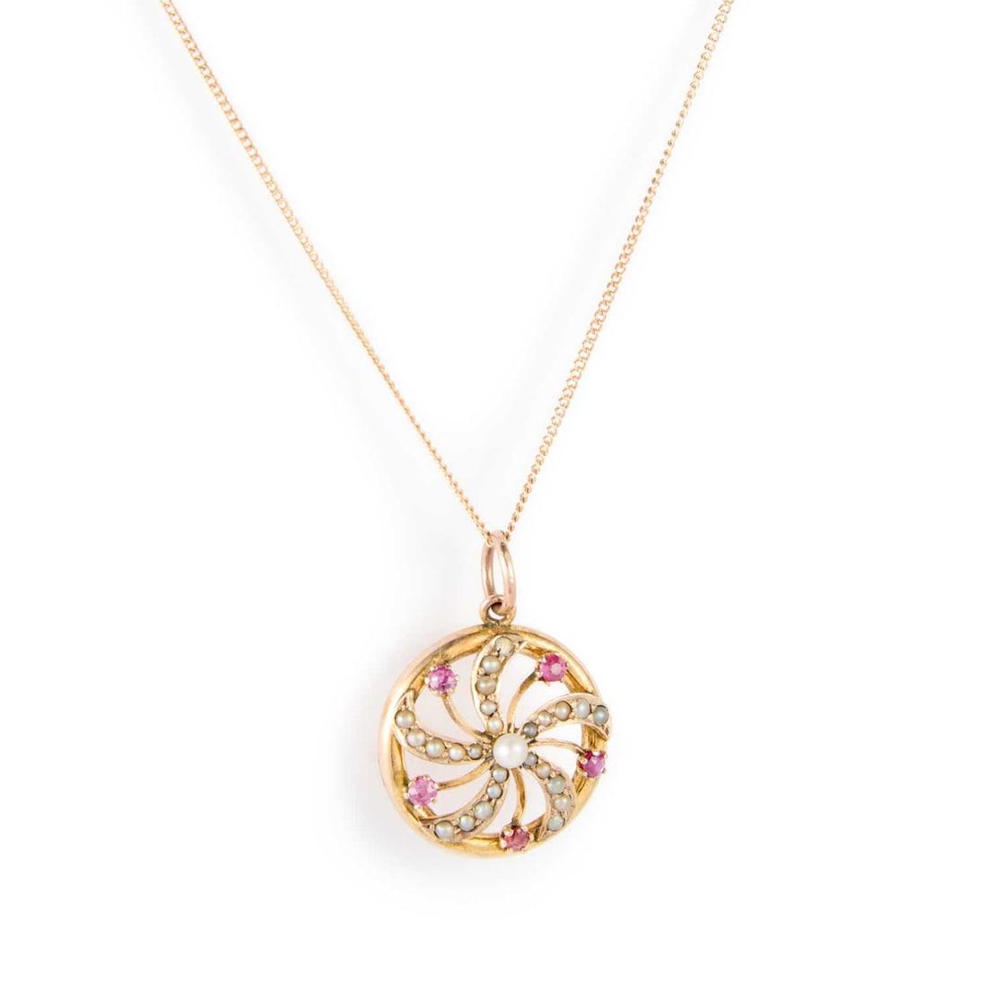 AN EDWARDIAN 9 CARAT GOLD RUBY AND SEED PEARL PENDANT ON CHAIN: AN EDWARDIAN 9 CARAT GOLD RUBY AND SEED PEARL PENDANT ON CHAIN a whirl motif set with seed pearls and rubies, within a circular frame, to a fine chain, hallmarked Chester 1904. 1.7cm diameter, 2.5