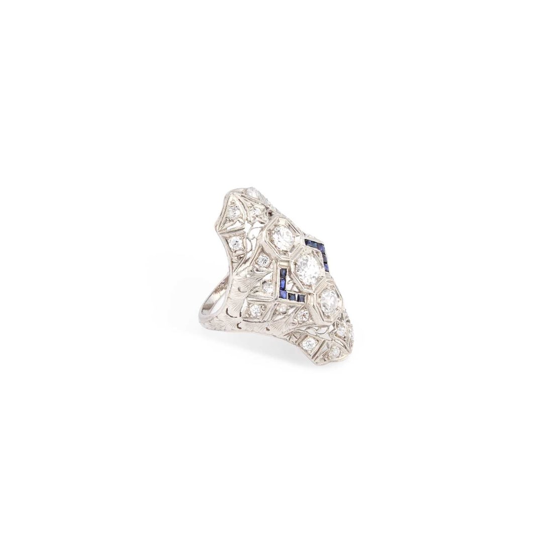 AN ART DECO SAPPHIRE AND DIAMOND DRESS RING: AN ART DECO SAPPHIRE AND DIAMOND DRESS RING three round-cut diamonds within a fancy pierced diamond-set navette frame with calibre-cut sapphire accents, stamped 'PLATINUM'. Estimated total diamond wei