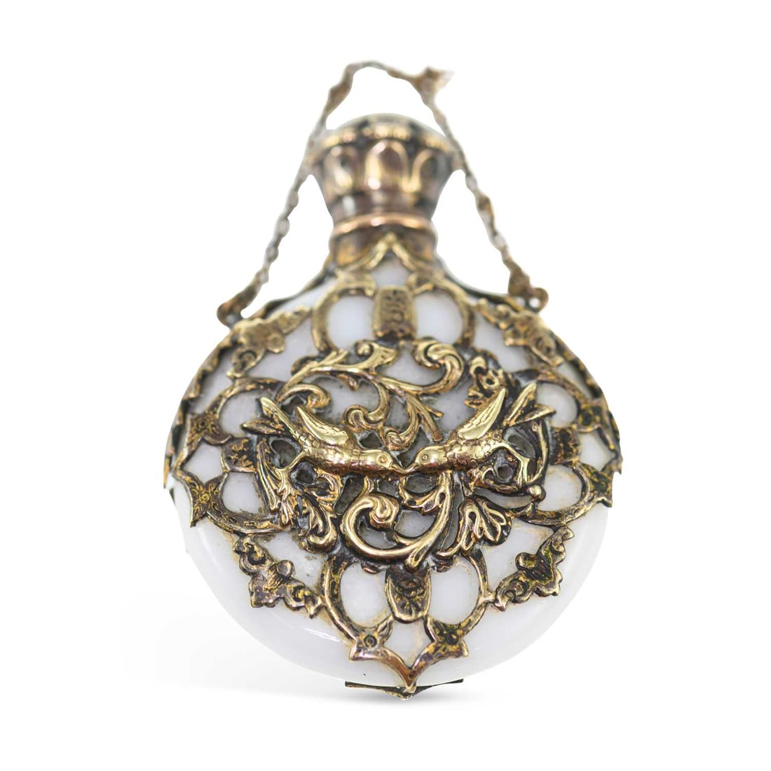 A 19TH CENTURY SILVER-GILT MOUNTED OPALINE GLASS SCENT BOTTLE: A 19TH CENTURY SILVER-GILT MOUNTED OPALINE GLASS SCENT BOTTLE unmarked, the pierced silver mount decorated in relief with birds and scrolls. 6cm high