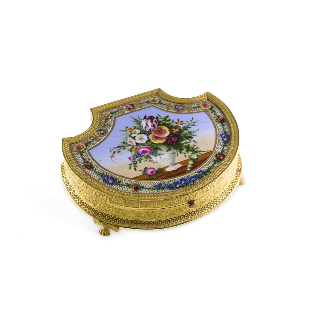 A FRENCH PALAIS ROYAL GILT-METAL AND PORCELAIN SEWING NÉCESSAIRE 19TH CENTURY: A FRENCH PALAIS ROYAL GILT-METAL AND PORCELAIN SEWING NÉCESSAIRE 19TH CENTURY the shield-shaped hinged cover painted with a floral still life within richly gilt borders, opening to reveal a fitted in