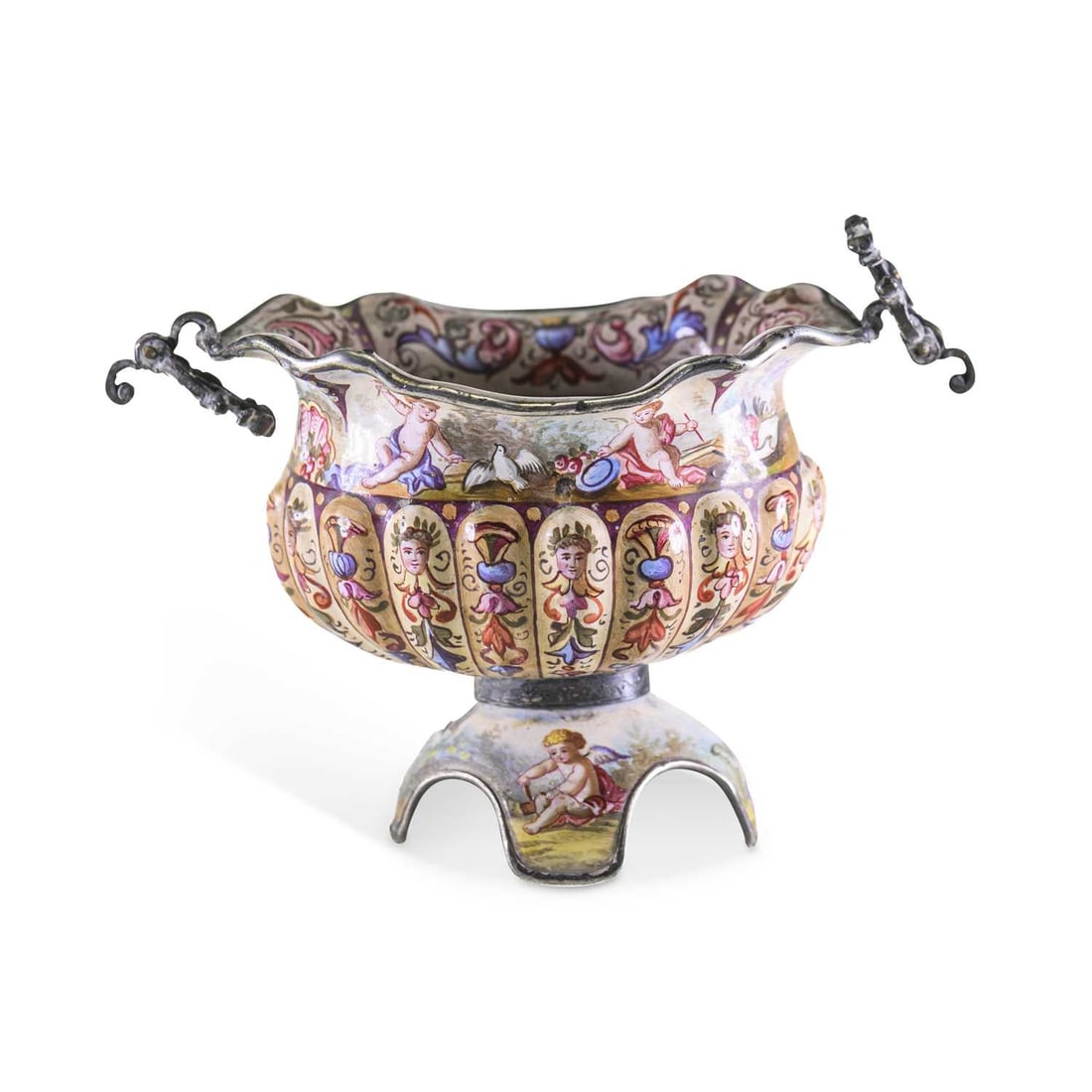 A VIENNESE SILVER AND ENAMEL TWO-HANDLED BOWL LATE 19TH CENTURY: A VIENNESE SILVER AND ENAMEL TWO-HANDLED BOWL LATE 19TH CENTURY of lobed form, painted with putti, masks and foliate scrollwork, raised on a shaped four-footed pedestal base and fitted with scroll han