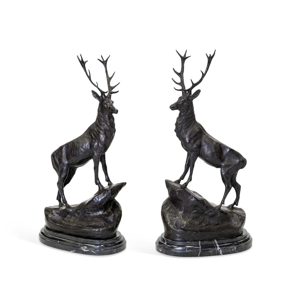 AFTER MOIGNIEZ, A LARGE PAIR OF BRONZE STAGS: AFTER MOIGNIEZ, A LARGE PAIR OF BRONZE STAGS each cast standing on a rock outcrop, raised on marble bases. (2) 75cm high