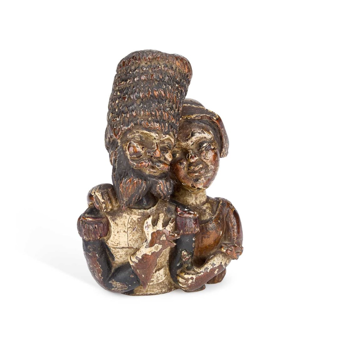 A POLYCHROME WOOD CARVING OF A COUPLE 18TH CENTURY: A POLYCHROME WOOD CARVING OF A COUPLE 18TH CENTURY amusingly carved as a young girl looking adoringly at her soldier boyfriend, retaining original painted decoration. 19.5cm high, 13.5cm wide