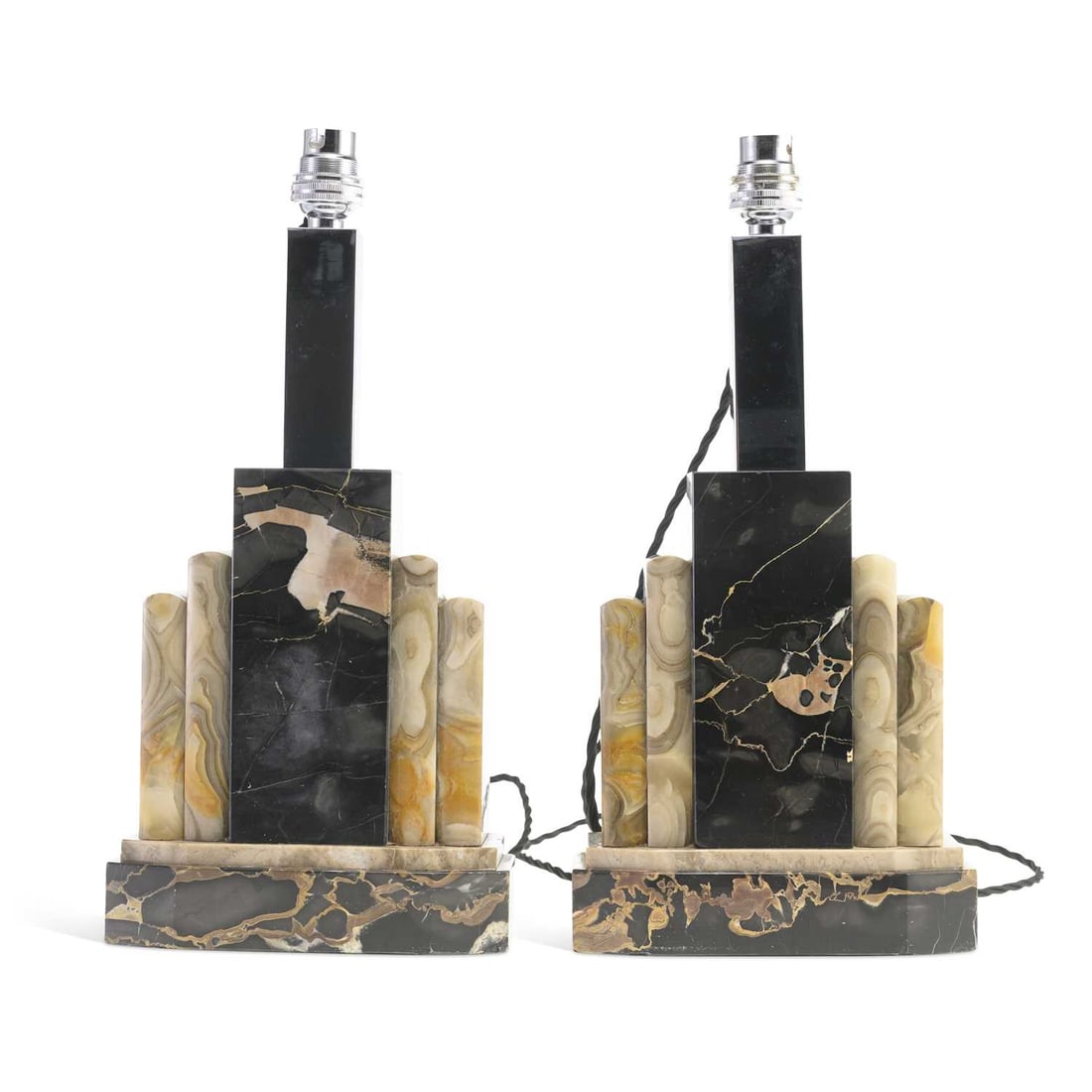 V A PAIR OF ART DECO MARBLE GARNITURES: V A PAIR OF ART DECO MARBLE GARNITURES converted to table lamps, the stepped and curved architectural bases inset with square-section chromed columns. (2) Marble 20.8cm high, 35.8cm high overall (incl