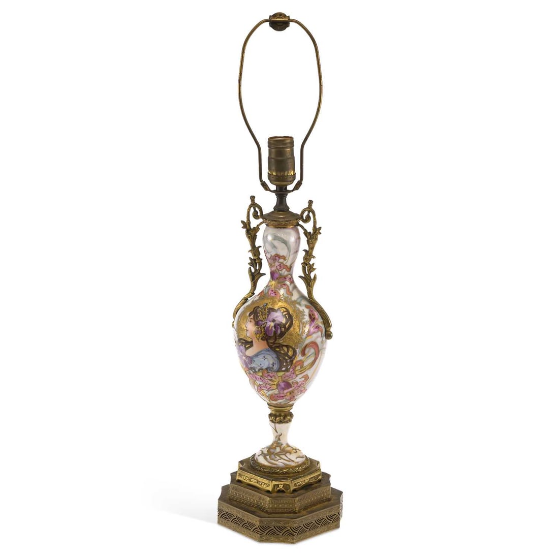 A FRENCH GILT METAL MOUNTED PORCELAIN LAMP CIRCA 1915: A FRENCH GILT METAL MOUNTED PORCELAIN LAMP CIRCA 1915 decorated in Art Nouveau taste, with a girl amongst flowering plants, having gilt handles and mounts. 64cm high