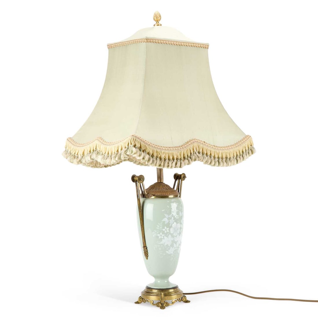 A FRENCH PORCELAIN PÂTE-SUR-PÂTE LAMP CIRCA 1900: A FRENCH PORCELAIN PÂTE-SUR-PÂTE LAMP CIRCA 1900 with flowering plants on a celadon ground, having gilt metal handles and set upon a scroll footed metal base. 49cm high Metal work slightly tarnished
