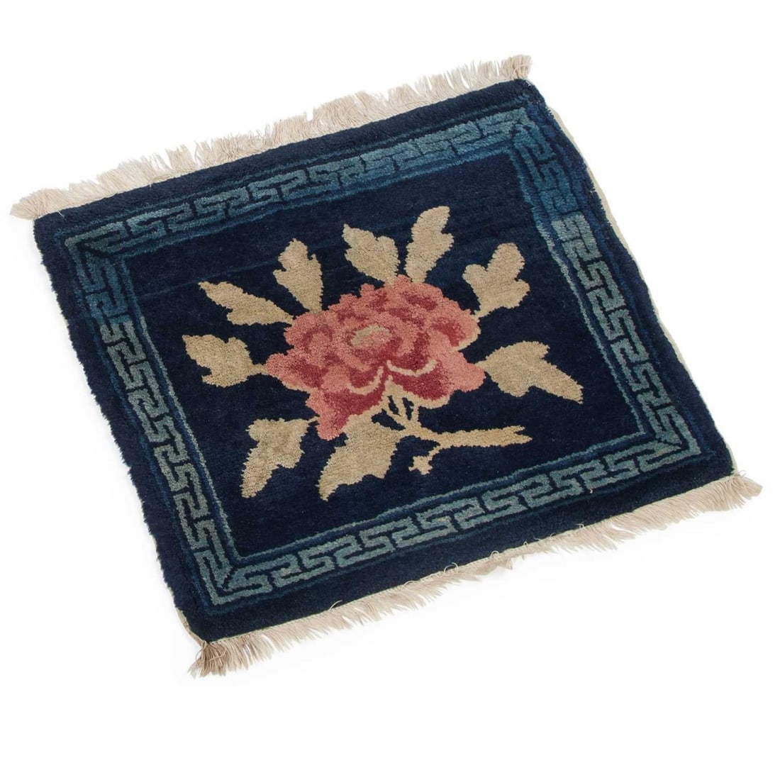 A CHINESE BAOTOU SEAT COVER CIRCA 1920: A CHINESE BAOTOU SEAT COVER CIRCA 1920 with a single flower spray. 45.5cm by 41cm