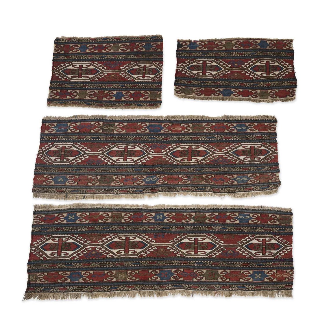 FOUR CAUCASIAN BAG FACES AND TENT HANGINGS: FOUR CAUCASIAN BAG FACES AND TENT HANGINGS each worked with repeating geometric medallions and stylised motifs in muted red, blue, ivory and brown, with fringed edges, comprising two larger and two sm