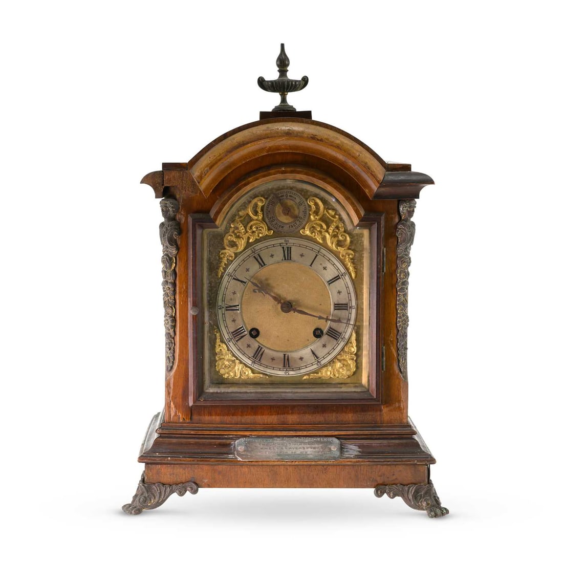 A LATE 19TH CENTURY WALNUT BRACKET CLOCK: A LATE 19TH CENTURY WALNUT BRACKET CLOCK the arched case surmounted by an urn finial and applied with caryatid mounts, the silvered chapter ring with Roman numerals enclosing a gilt centre, beneath a 