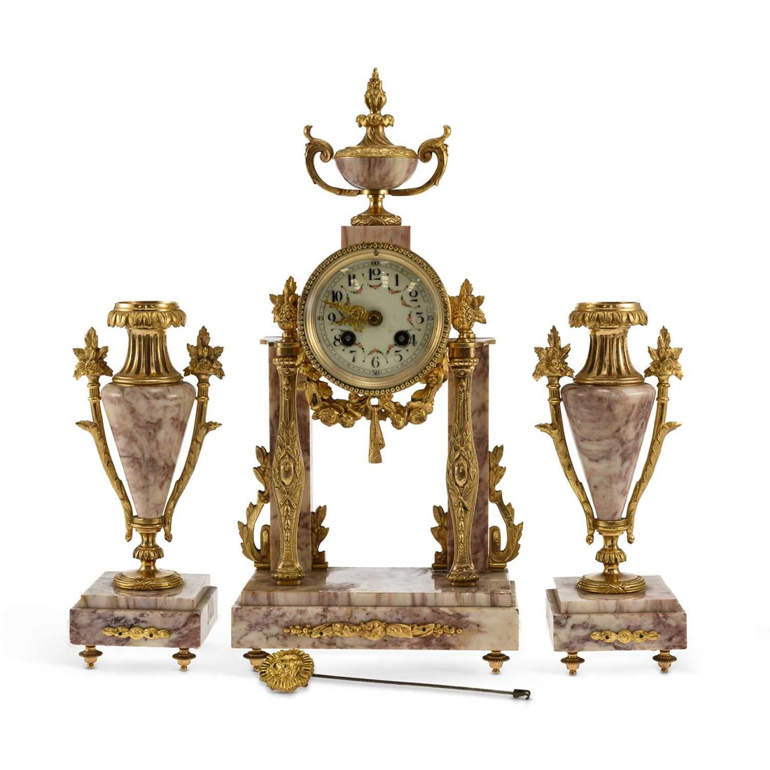 A LATE 19TH CENTURY FRENCH GILT-METAL AND MARBLE THREE-PIECE CLOCK GARNITURE: A LATE 19TH CENTURY FRENCH GILT-METAL AND MARBLE THREE-PIECE CLOCK GARNITURE the portico clock surmounted by a twin-handled urn, the dial painted with floral swags and Arabic numerals, raised on four 
