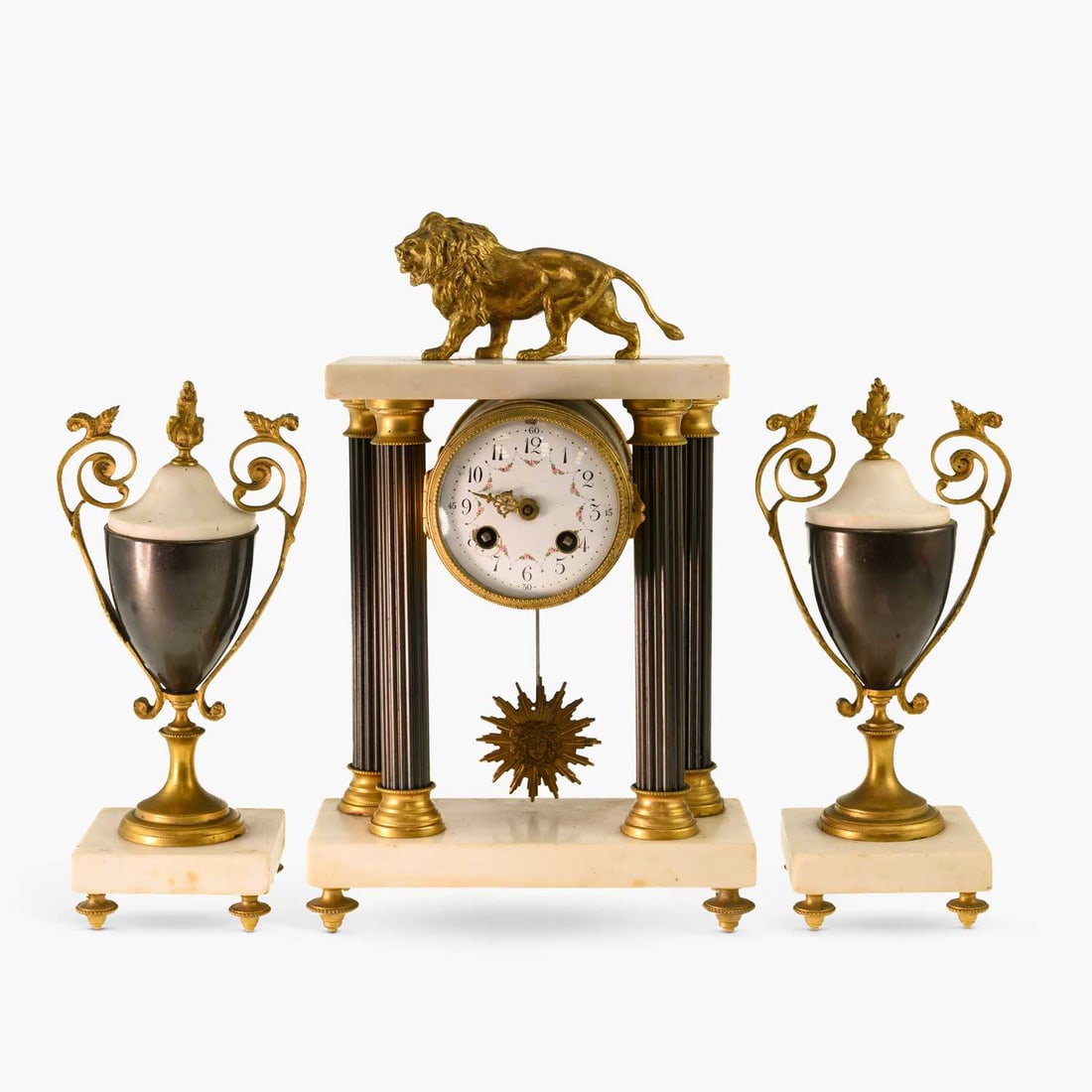A LATE 19TH CENTURY FRENCH GILT-METAL, PATINATED METAL AND MARBLE PORTICO CLOCK GARNITURE: A LATE 19TH CENTURY FRENCH GILT-METAL, PATINATED METAL AND MARBLE PORTICO CLOCK GARNITURE the clock surmounted by a gilt lion above four fluted columns, enclosing a circular floral-painted enamel dial