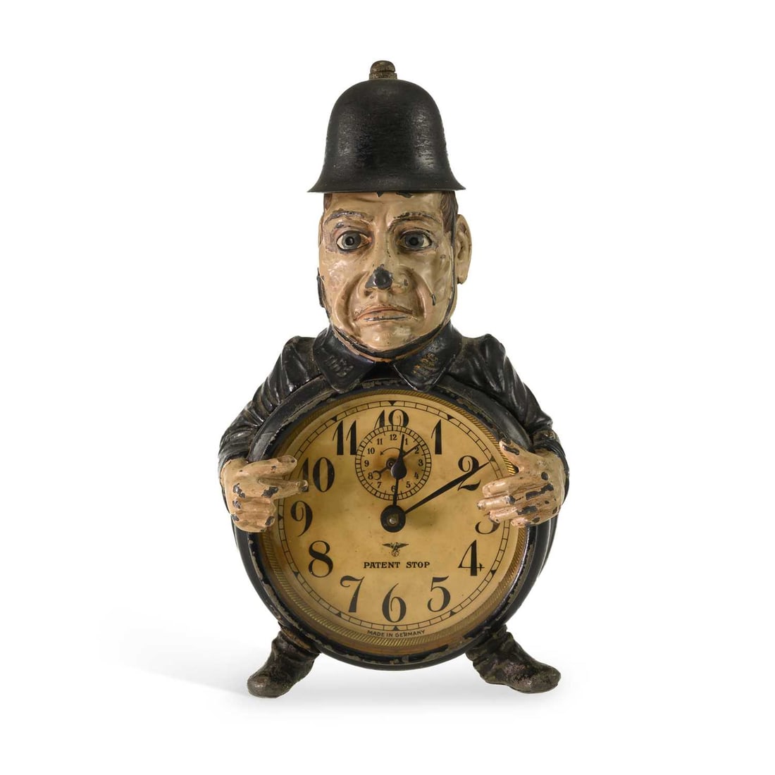 A F.M.S. NOVELTY POLICEMAN ALARM CLOCK CIRCA 1925: A F.M.S. NOVELTY POLICEMAN ALARM CLOCK CIRCA 1925 the Friedrich Mauthe Schwenningen cast iron clock in the form of a rotund policeman, stamped marks to the reverse. 22.5cm high
