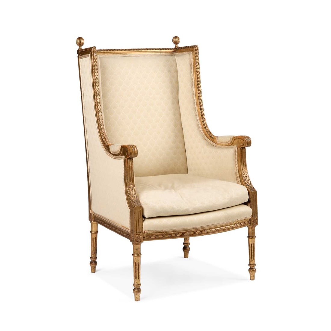 A LOUIS XVI STYLE GILTWOOD BERGERE: A LOUIS XVI STYLE GILTWOOD BERGERE the rectangular padded back with turned finials above shaped wing sides. Height of back 111cm