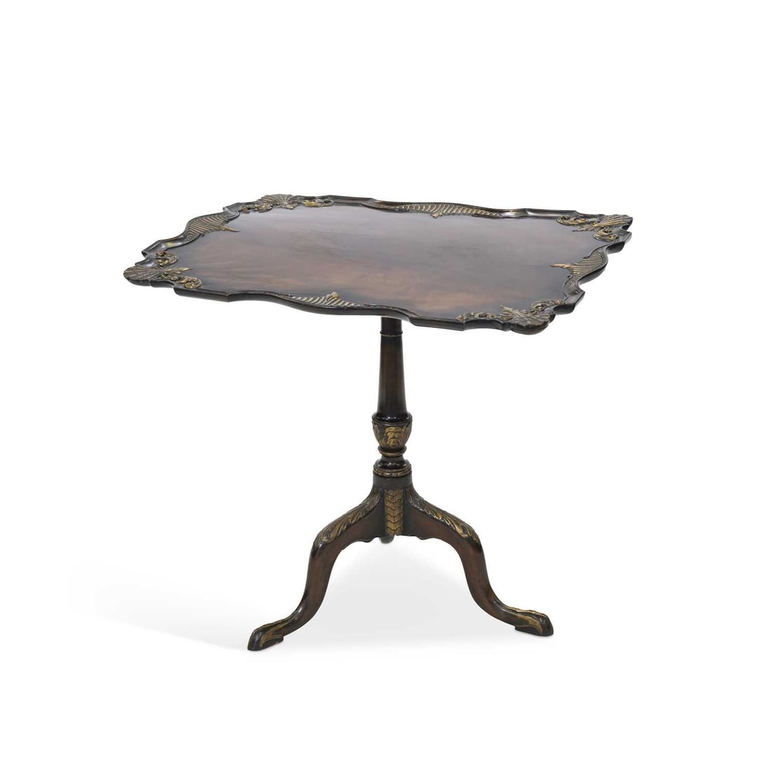 A 19TH CENTURY PARCEL-GILT AND CARVED MAHOGANY TILT-TOP TRIPOD TABLE: A 19TH CENTURY PARCEL-GILT AND CARVED MAHOGANY TILT-TOP TRIPOD TABLE the shaped rectangular top raised on a slender tapering stem continuing to downswept legs terminating in claw feet. 69cm high,