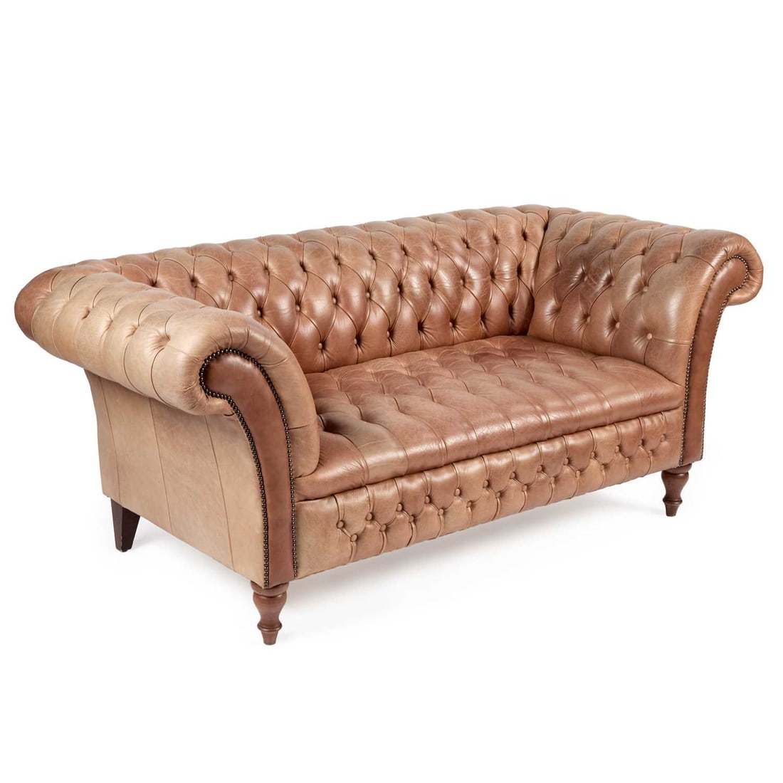A DEEP-BUTTONED TAN LEATHER CHESTERFIELD SOFA: A DEEP-BUTTONED TAN LEATHER CHESTERFIELD SOFA with turned forelegs. 186cm long