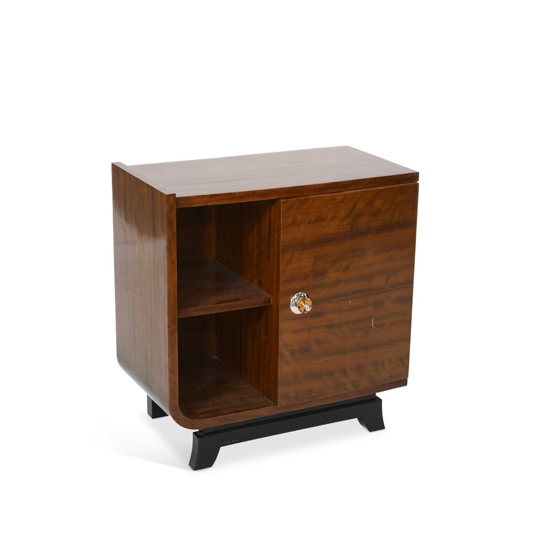 V AN ART DECO WALNUT VENEERED SIDE CABINET: V AN ART DECO WALNUT VENEERED SIDE CABINET the rectangular top above an asymmetrical arrangement of two open shelves and a cupboard door with a glass knob, raised on an ebonised plinth base with shape
