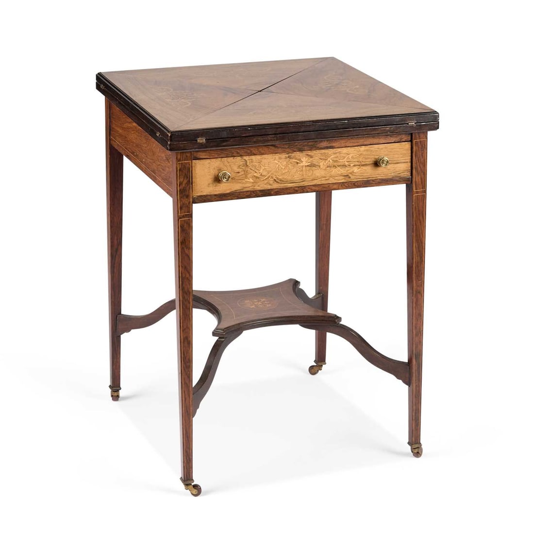 AN EDWARDIAN INLAID ROSEWOOD ENVELOPE CARD TABLE: AN EDWARDIAN INLAID ROSEWOOD ENVELOPE CARD TABLE square, with four triangular hinged leaves above a frieze drawer, inlaid with scrolling foliage, raised on square-section tapering legs joined by a she