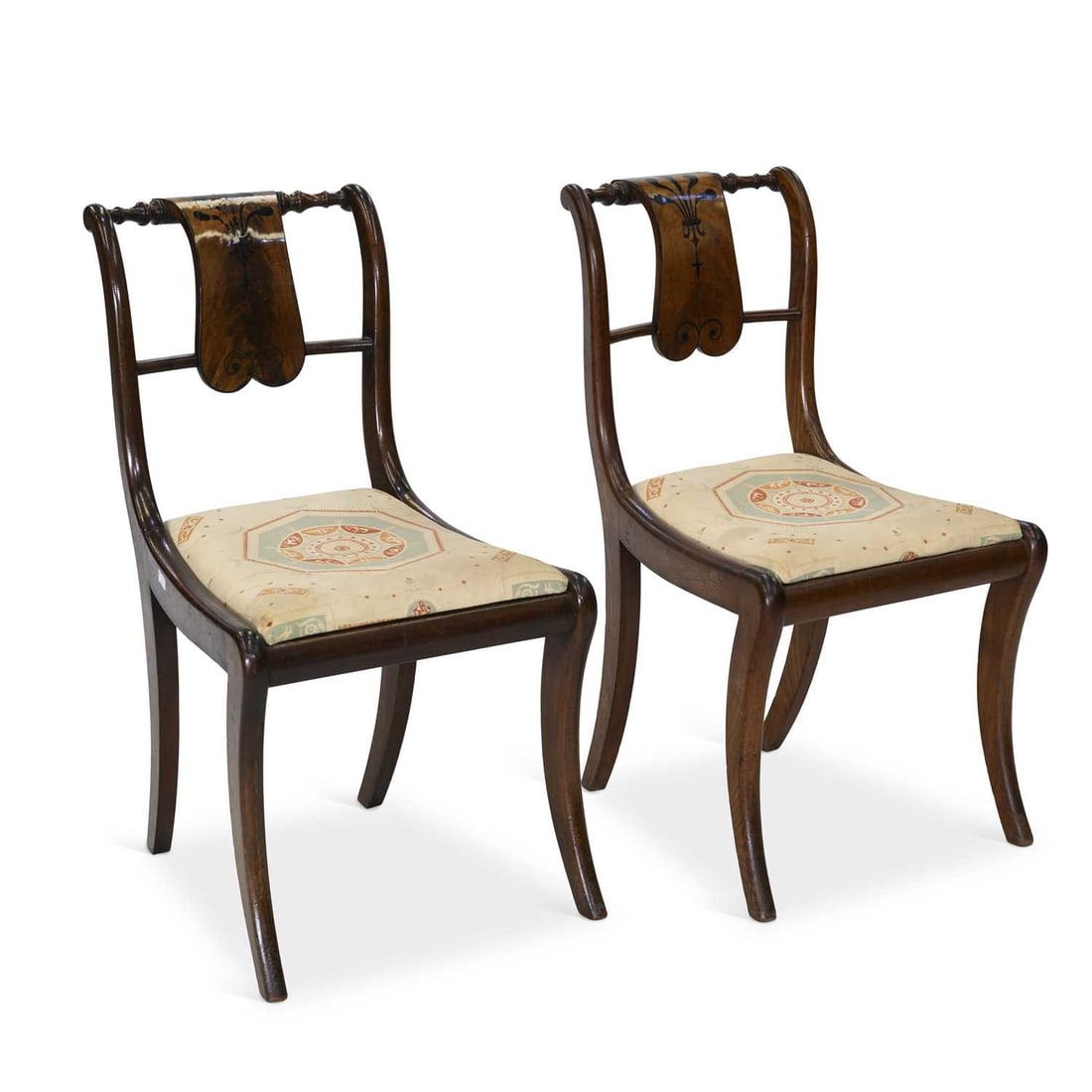 A PAIR OF REGENCY EBONY-INLAID MAHOGANY SIDE CHAIRS: A PAIR OF REGENCY EBONY-INLAID MAHOGANY SIDE CHAIRS each back with a curved tablet to the back, raised on sabre forelegs. (2) Height of backs 84cm