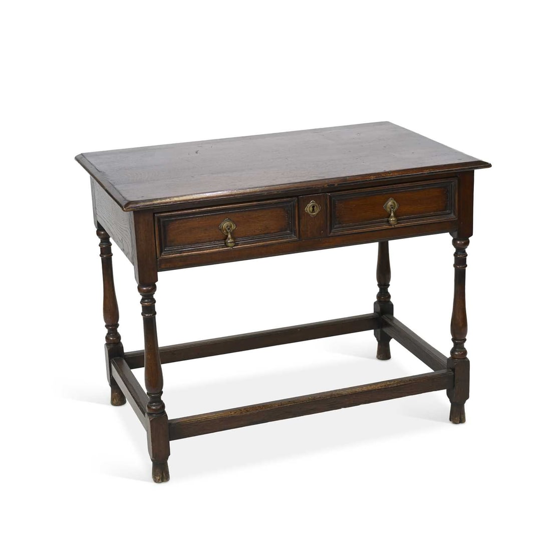 A 17TH CENTURY STYLE OAK SIDE TABLE 19TH CENTURY: A 17TH CENTURY STYLE OAK SIDE TABLE 19TH CENTURY the moulded rectangular top above a long frieze drawer, raised on block and baluster legs terminating in blocks joined by stretchers. 76cm high, 99cm