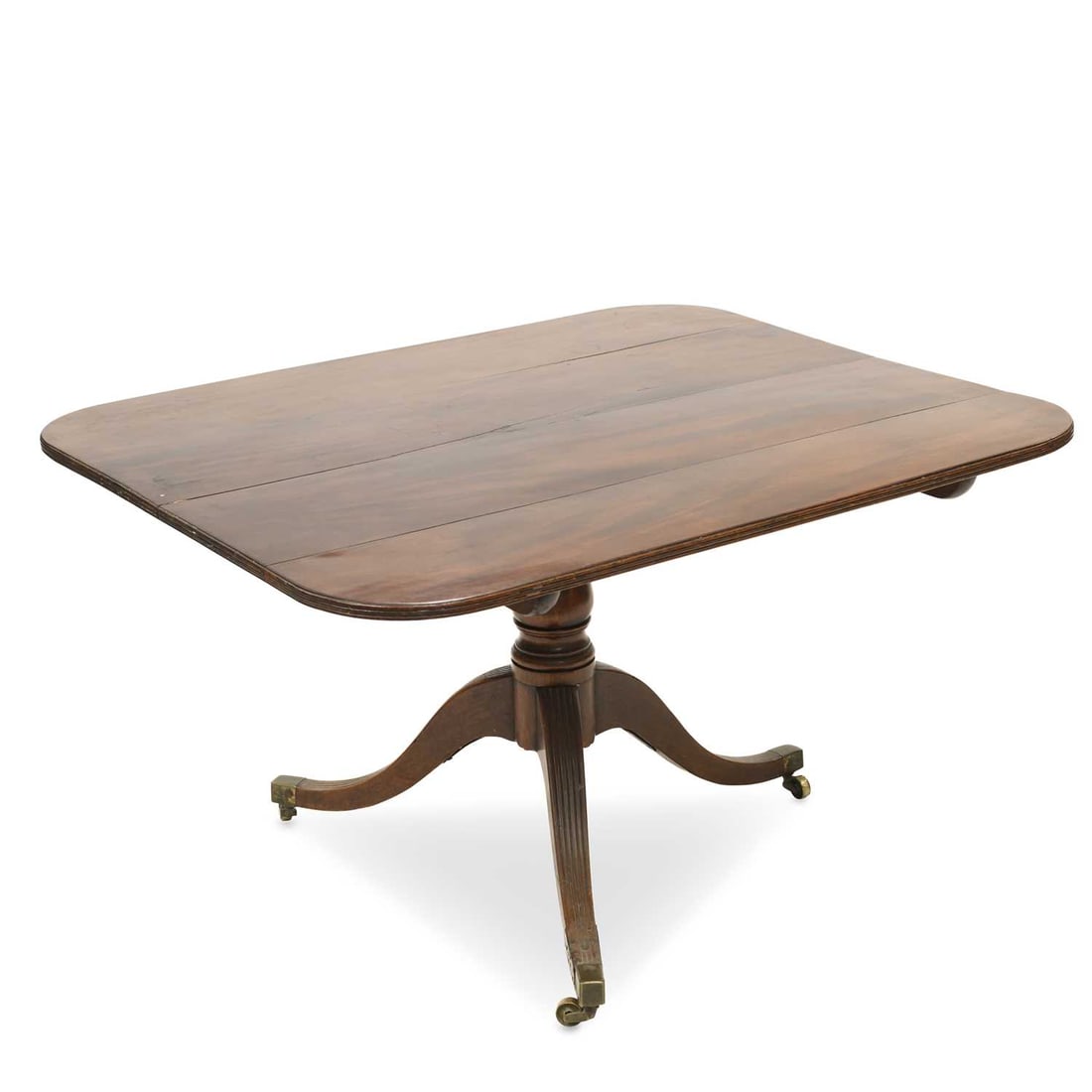 A REGENCY MAHOGANY TILT-TOP BREAKFAST TABLE: A REGENCY MAHOGANY TILT-TOP BREAKFAST TABLE the rectangular top with rounded corners and a reeded edge, raised on a baluster stem continuing to reeded downswept legs terminating in square brass caps a