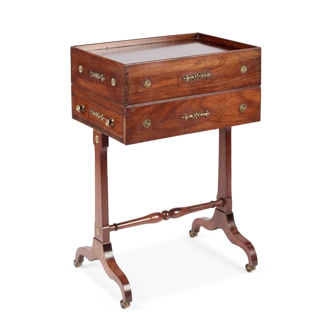 A RARE REGENCY MAHOGANY SLIPPER-MAKER'S WORK TABLE: A RARE REGENCY MAHOGANY SLIPPER-MAKER'S WORK TABLE the removable lift-off tray top reveals a three-quarter gallery and compartmented interior, above frieze drawers to both short sides, raised on taper