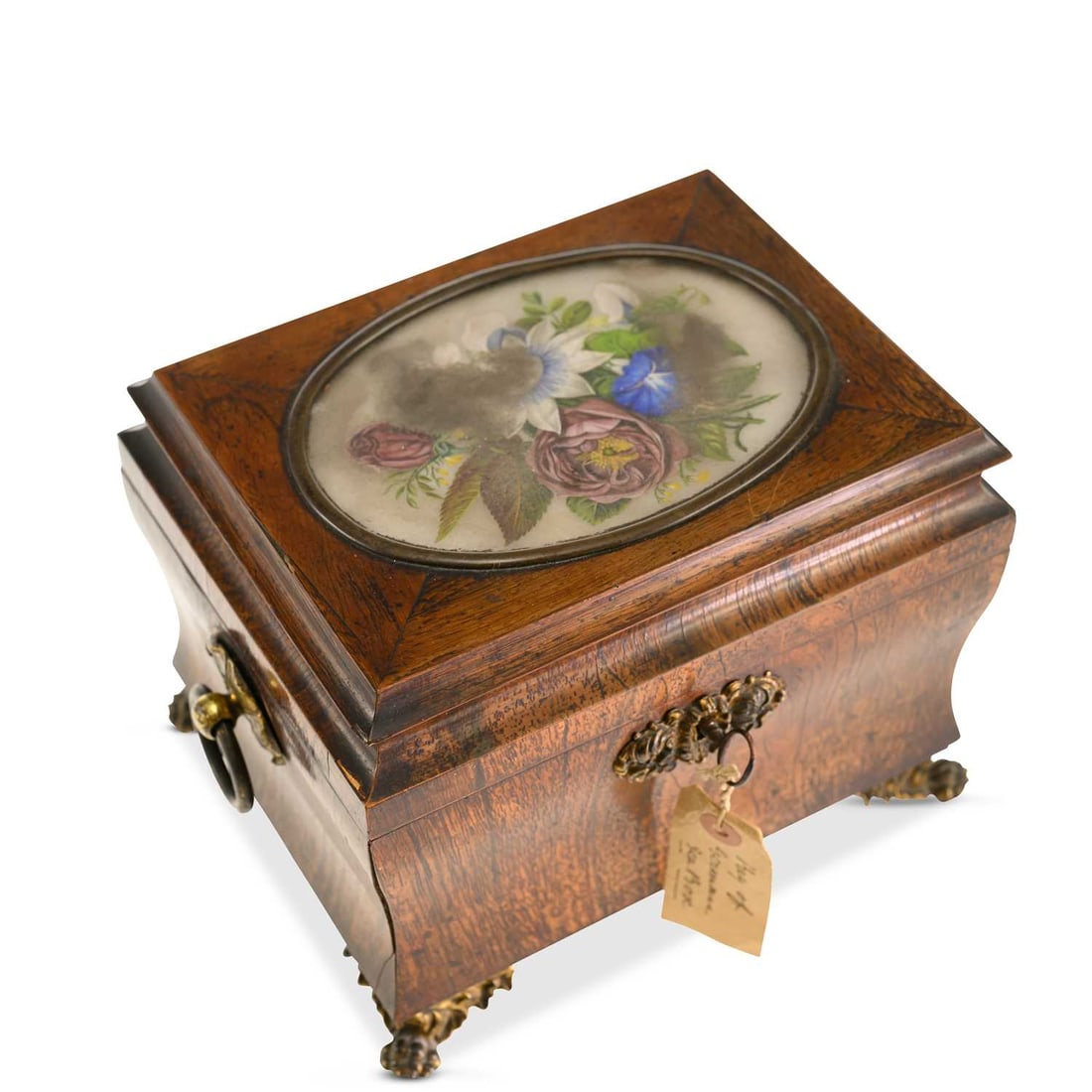 A 19TH CENTURY ROSEWOOD SARCOPHAGUS-FORM TEA CADDY: A 19TH CENTURY ROSEWOOD SARCOPHAGUS-FORM TEA CADDY the hinged cover inset with a glazed floral painted panel, enclosing a fitted interior with a cut-glass mixing bowl and lidded caddy, with