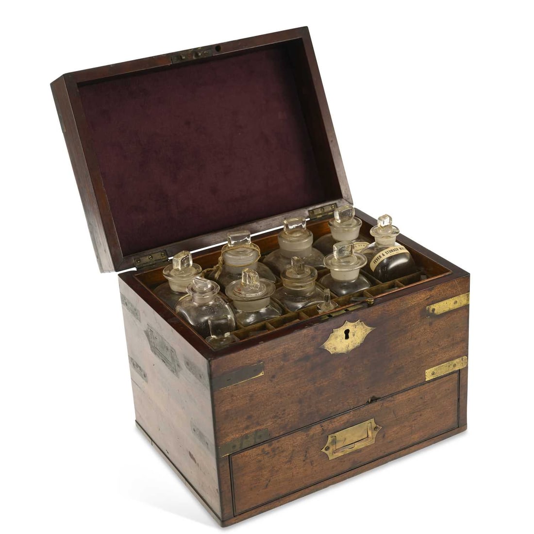 A 19TH CENTURY BRASS-BOUND MAHOGANY APOTHECARY’S CHEST: A 19TH CENTURY BRASS-BOUND MAHOGANY APOTHECARY’S CHEST the hinged cover enclosing a fitted interior containing assorted glass medicine bottles, above a base drawer, with brass escutcheon, recessed h