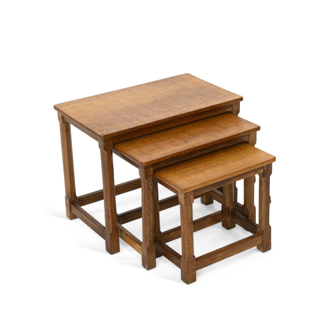 ROBERT THOMPSON OF KILBURN A NEST OF THREE MOUSEMAN OAK TABLES: ROBERT THOMPSON OF KILBURN A NEST OF THREE MOUSEMAN OAK TABLES of rectangular form with adzed tops, each with a carved mouse signature. (3) 47.5cm high, 61cm wide, 37cm deep